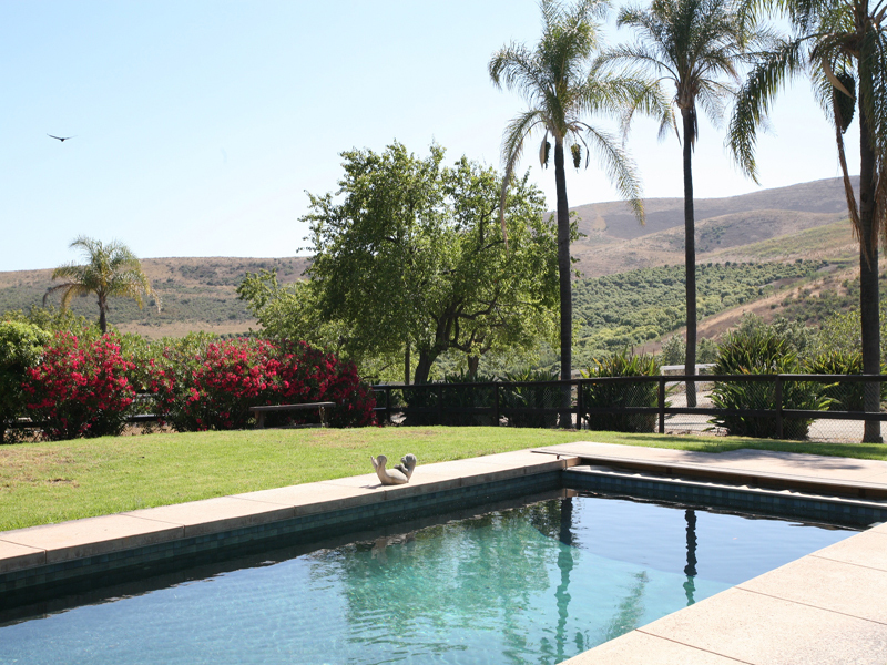 575 Refugio Road Goleta, CA 93117 - Photo 2 of 6 a view of swimming pool with a bench and lake view