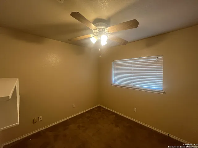 a view of an empty room and window fan