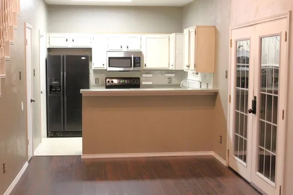 a kitchen with stainless steel appliances a refrigerator and a stove top oven