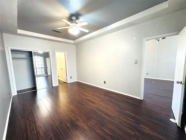 a view of an empty room with wooden floor