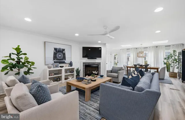a living room with furniture a fireplace and a flat screen tv