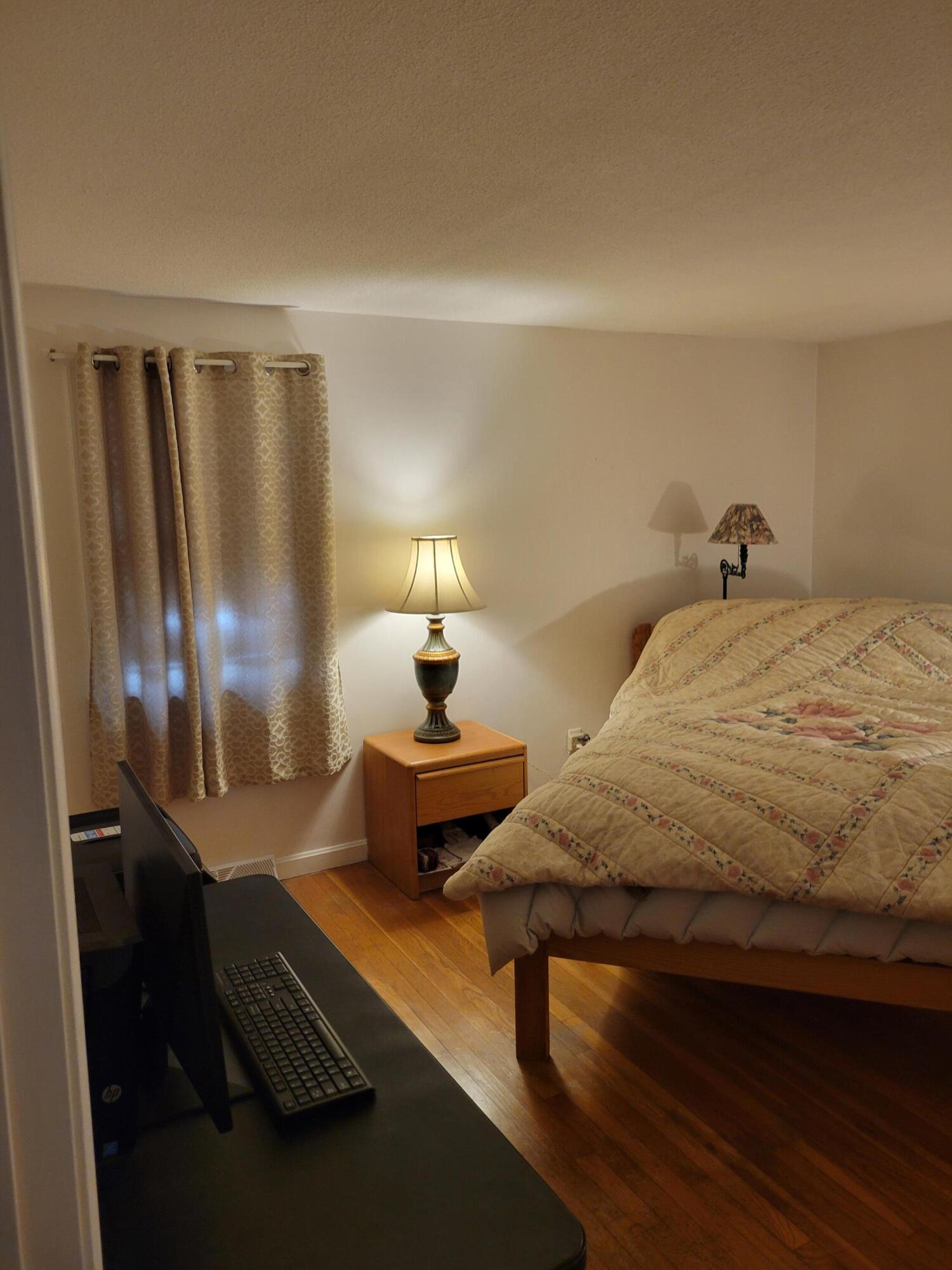 115 Captain Chase Road South Yarmouth, MA 02664 - Photo 24 of 36 a bedroom with a bed and lamp