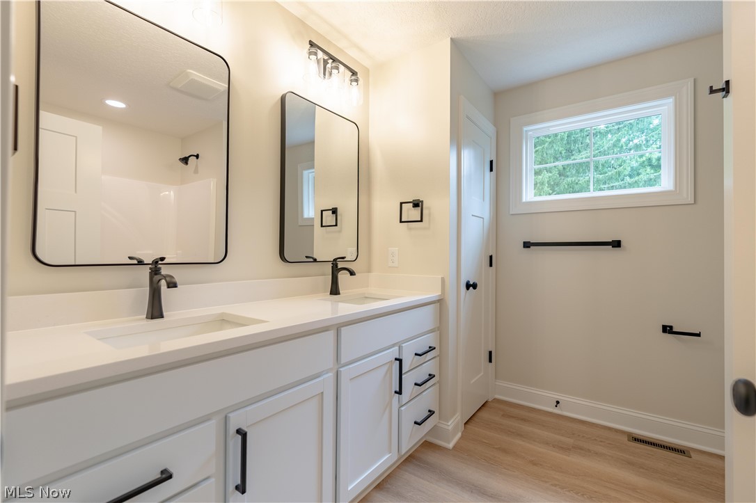 7876 Burkey Road Northwest North Canton, OH 44720 - Photo 21 of 40 Bright white master bathroom with dual vanity.
