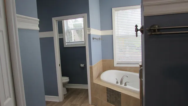 a bathroom with a tub a toilet and a sink