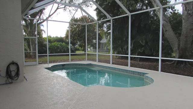 a view of a swimming pool with a sink and wooden floor