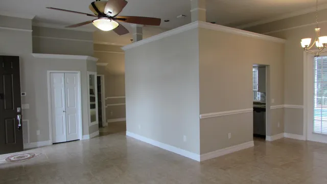 an empty room with closet and windows