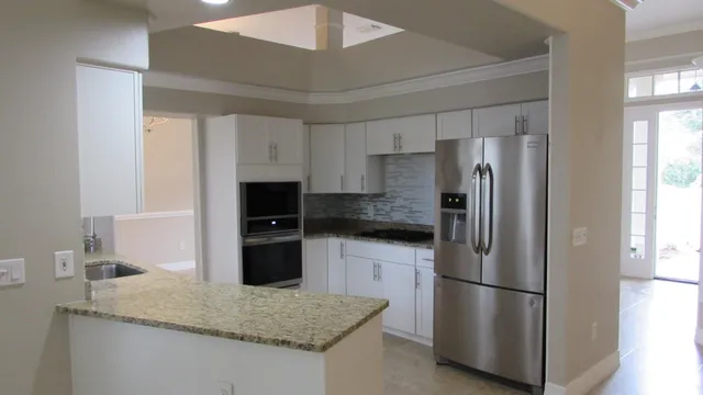 a kitchen with a refrigerator a stove and a sink