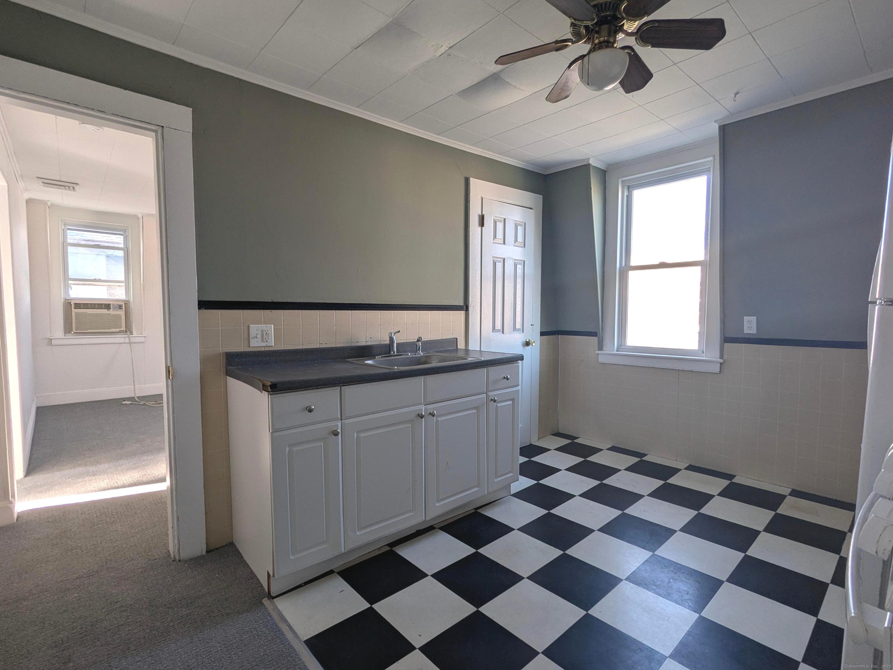 45 White Street Shelton, CT 06484 - Photo 3 of 10 a kitchen with a black white checkered floor