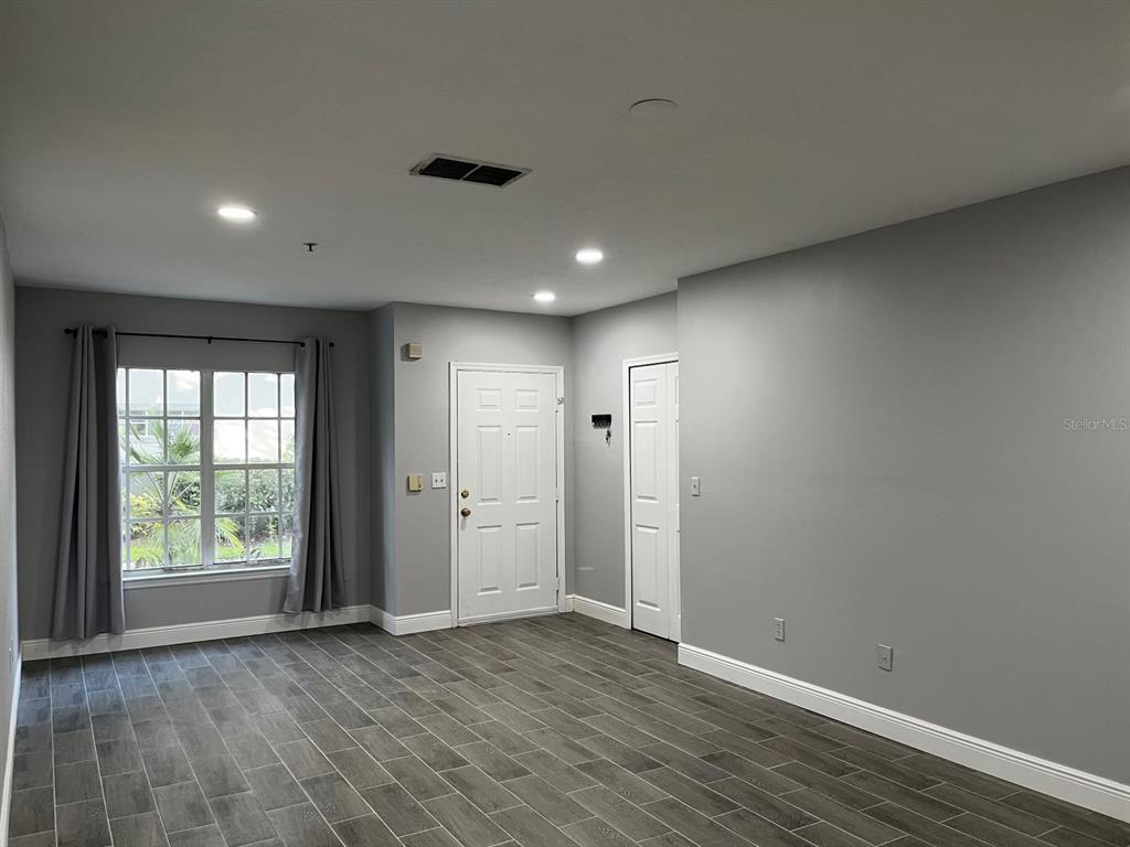 4352 South Kirkman Road, Unit 1203 Orlando, FL 32811 - Photo 5 of 27 View of family room and front door from the kitchen