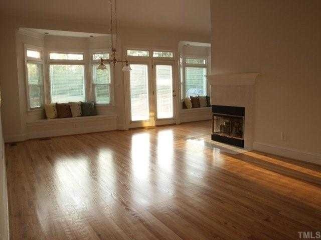 2992 Tillinghast Trail Raleigh, NC 27613 - Photo 3 of 12 Freshly refinished floors, cathedral ceilings, a three sided gas log fireplace and window seats (with concealed storage) offering a wonderful view of the 9th green. Den/Family/Great Room