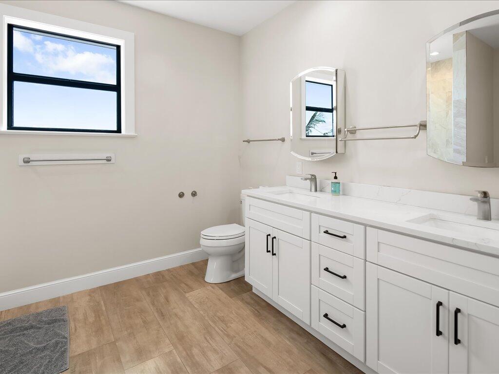 232 Harbor Place North Goodland, FL 34140 - Photo 14 of 24 a bathroom with a toilet sink and mirror