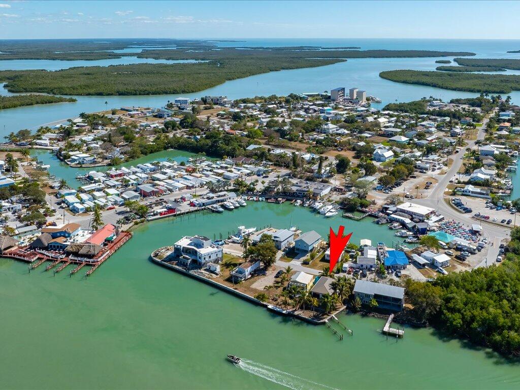 232 Harbor Place North Goodland, FL 34140 - Photo 24 of 24 a aerial view of a house with a garden and lake view