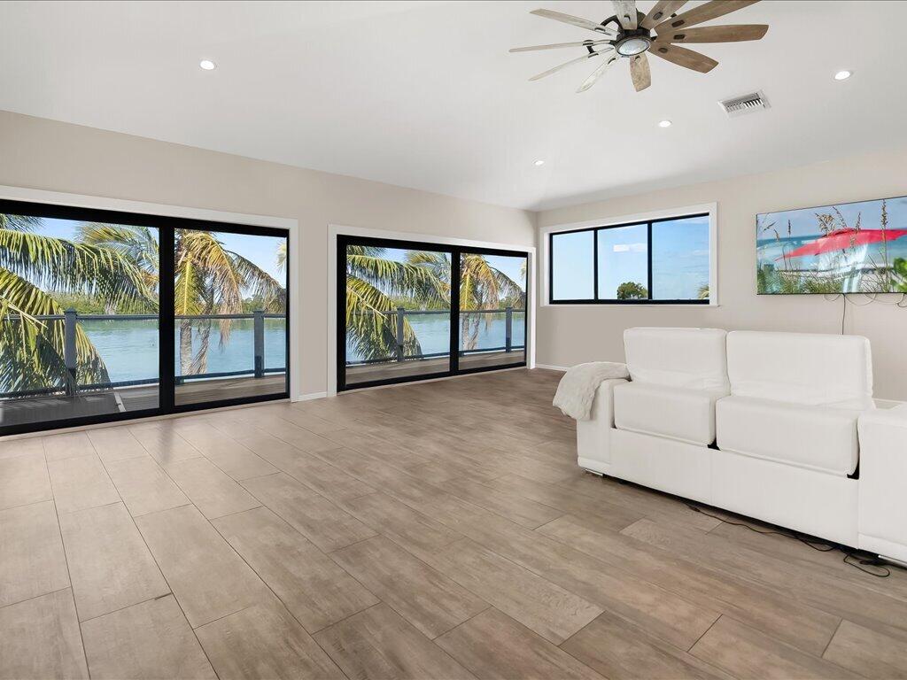 232 Harbor Place North Goodland, FL 34140 - Photo 7 of 24 a view of an empty room with a window and wooden floor