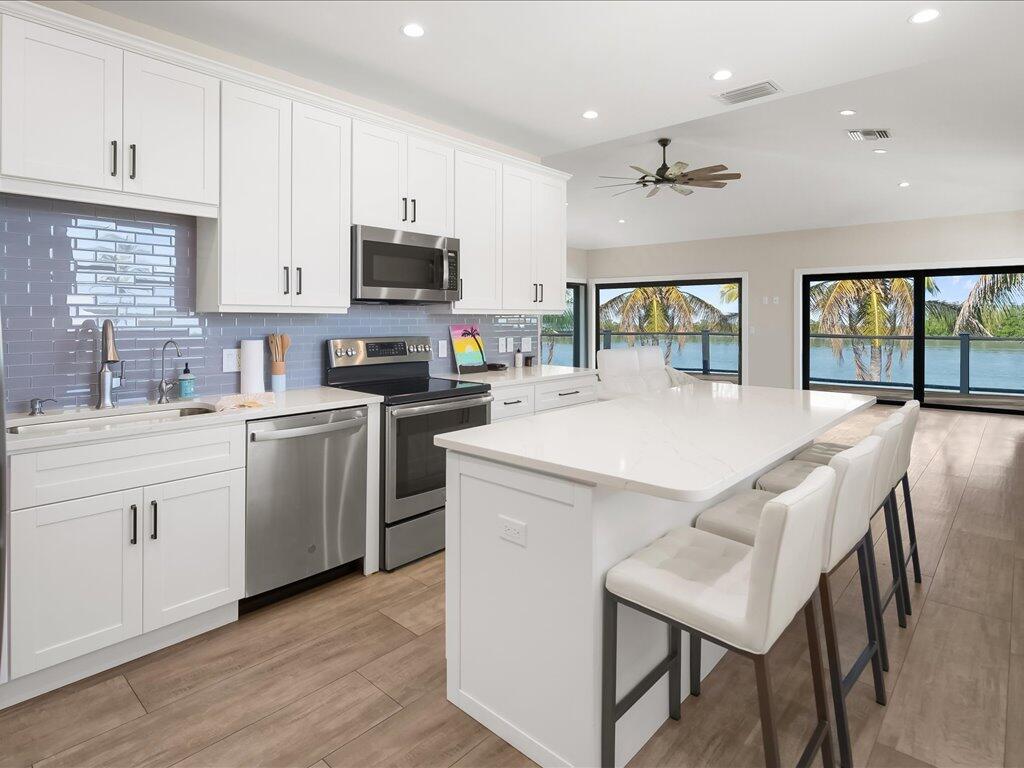 232 Harbor Place North Goodland, FL 34140 - Photo 8 of 24 a kitchen with sink a microwave and cabinets