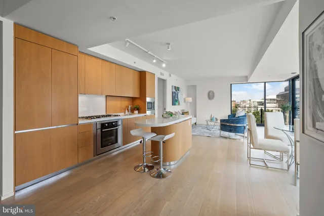 a kitchen with stainless steel appliances granite countertop a sink and a microwave