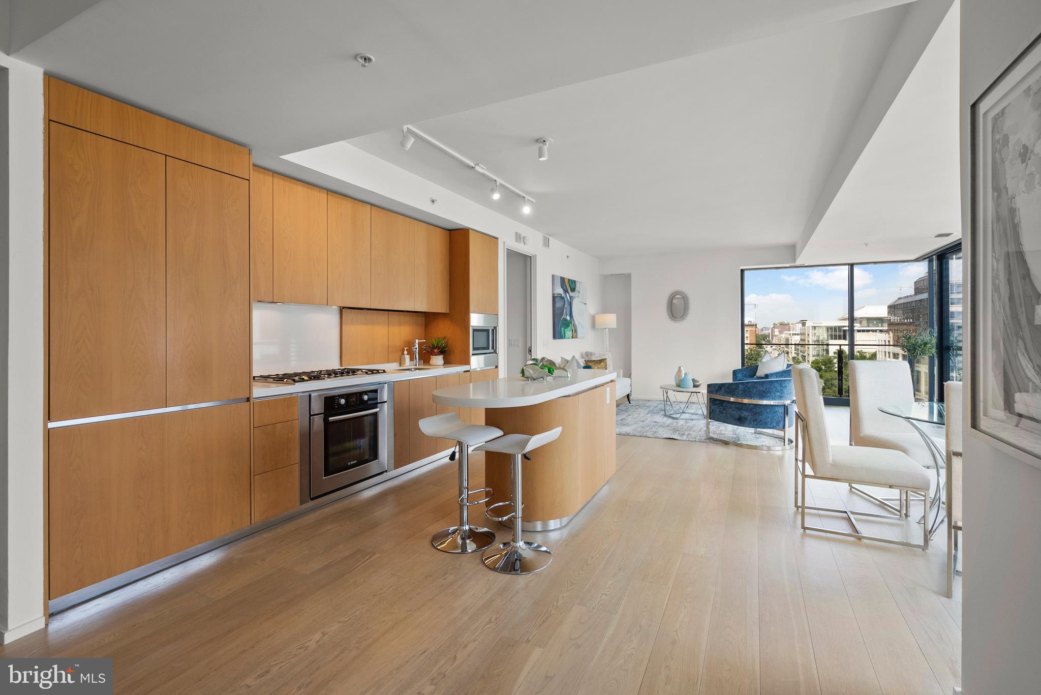 920 I Street Northwest, Unit 1009 Washington, DC 20001 - Photo 14 of 75 a kitchen with a refrigerator a stove cabinets and living room view