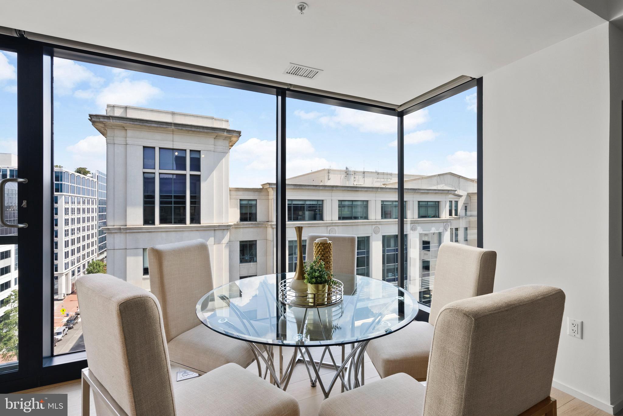 920 I Street Northwest, Unit 1009 Washington, DC 20001 - Photo 21 of 75 a dining room with furniture a large window and wooden floor