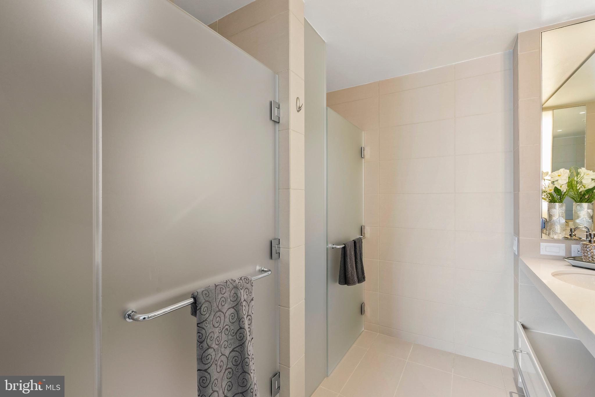 920 I Street Northwest, Unit 1009 Washington, DC 20001 - Photo 29 of 75 a bathroom with a granite countertop shower and a sink