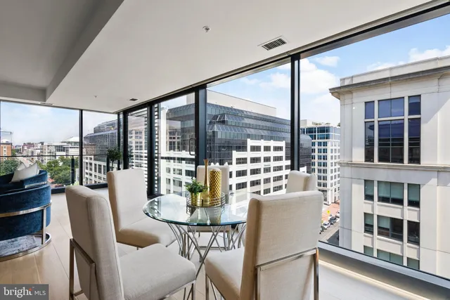 a bedroom with a bed and a potted plant on the dresser