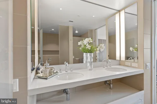 a dining room with furniture water view and a floor to ceiling window