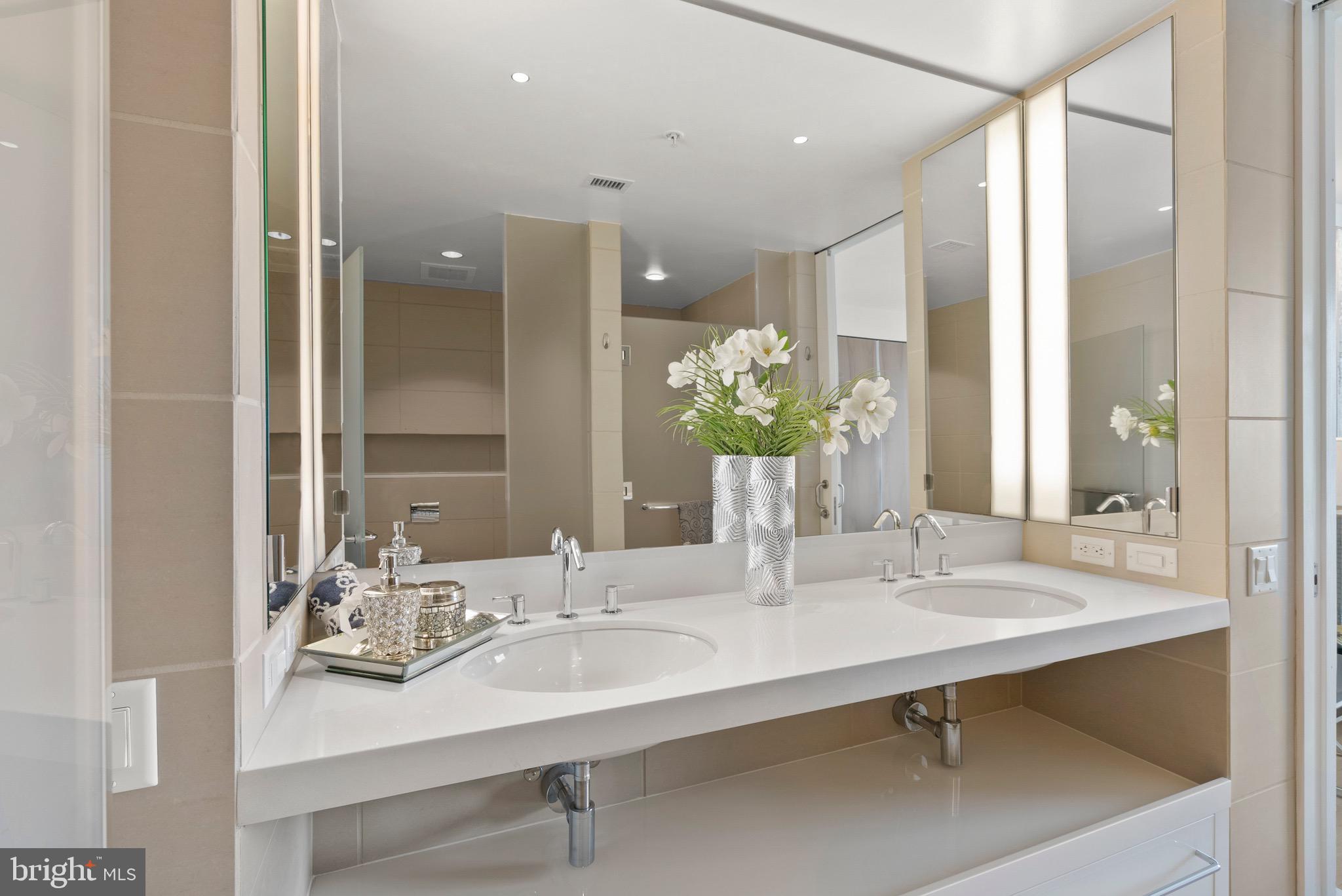 920 I Street Northwest, Unit 1009 Washington, DC 20001 - Photo 32 of 75 a bathroom with a sink and a mirror