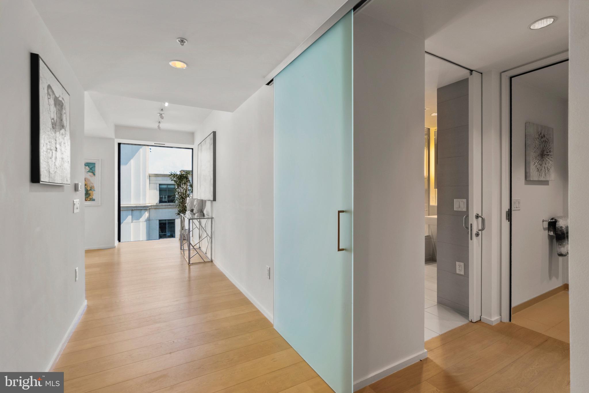 920 I Street Northwest, Unit 1009 Washington, DC 20001 - Photo 4 of 75 a view of a hallway with wooden floor and a living room