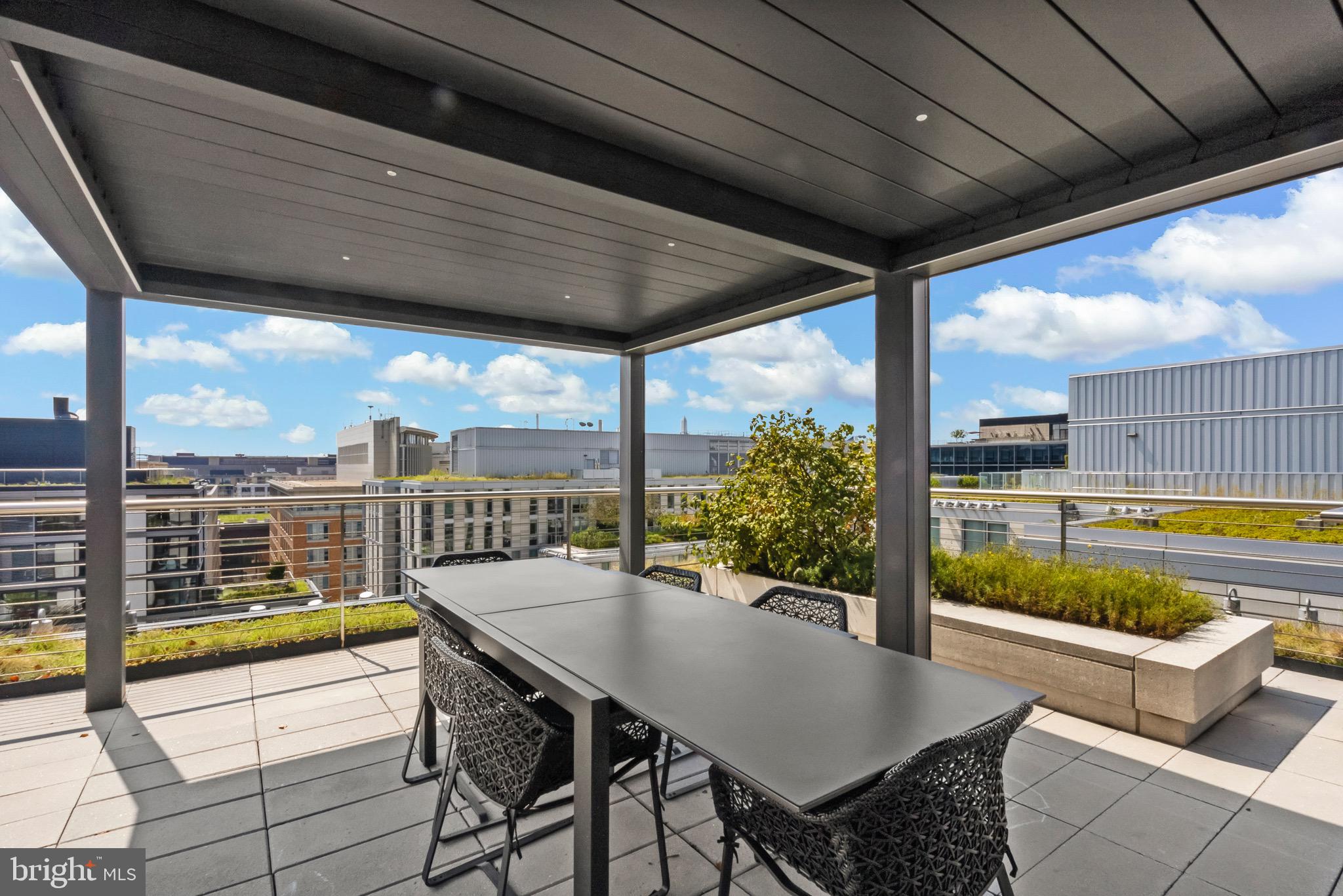 920 I Street Northwest, Unit 1009 Washington, DC 20001 - Photo 41 of 75 a view of a patio with a table and chairs