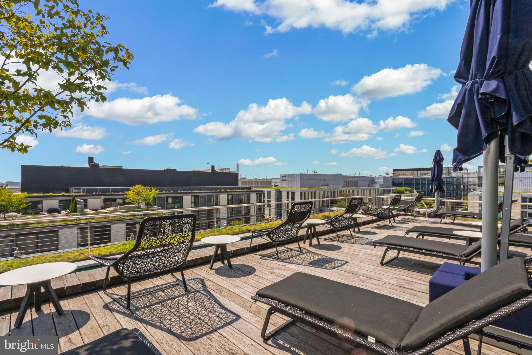 920 I Street Northwest, Unit 1009 Washington, DC 20001 - Photo 45 of 75 a view of a balcony with chairs and a potted plant