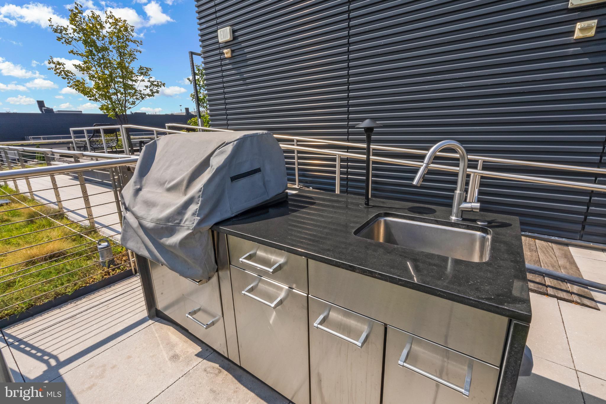 920 I Street Northwest, Unit 1009 Washington, DC 20001 - Photo 47 of 75 a view of a patio with table and chairs with wooden floor and fence