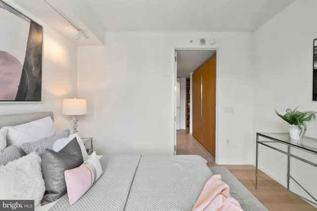 a bedroom with a bed and a large window