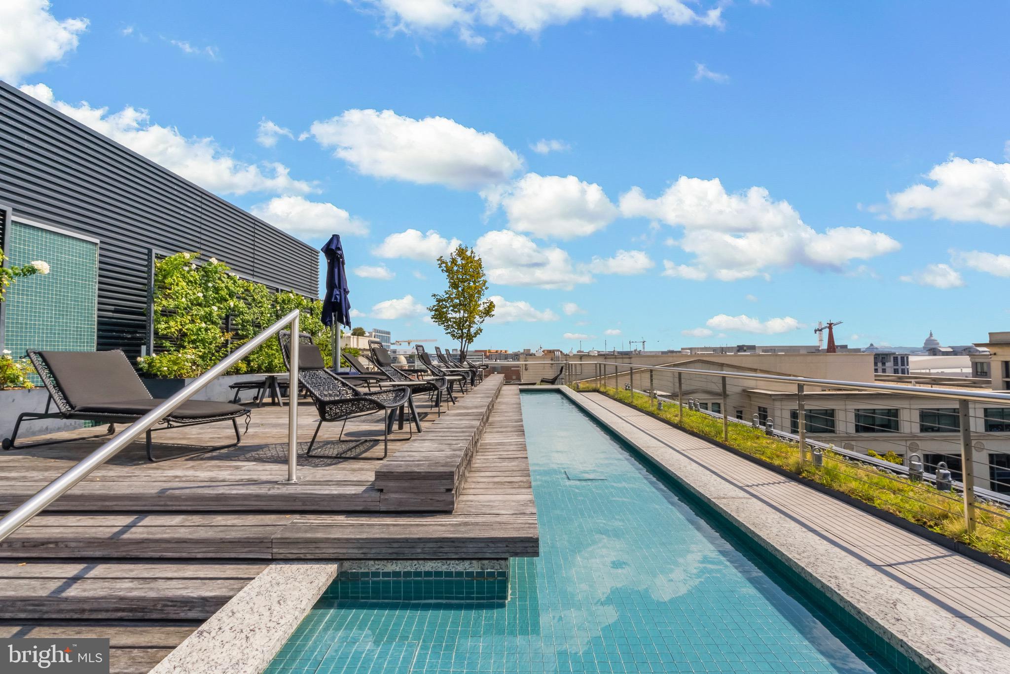 920 I Street Northwest, Unit 1009 Washington, DC 20001 - Photo 51 of 75 a view of a balcony with wooden floor and iron stairs