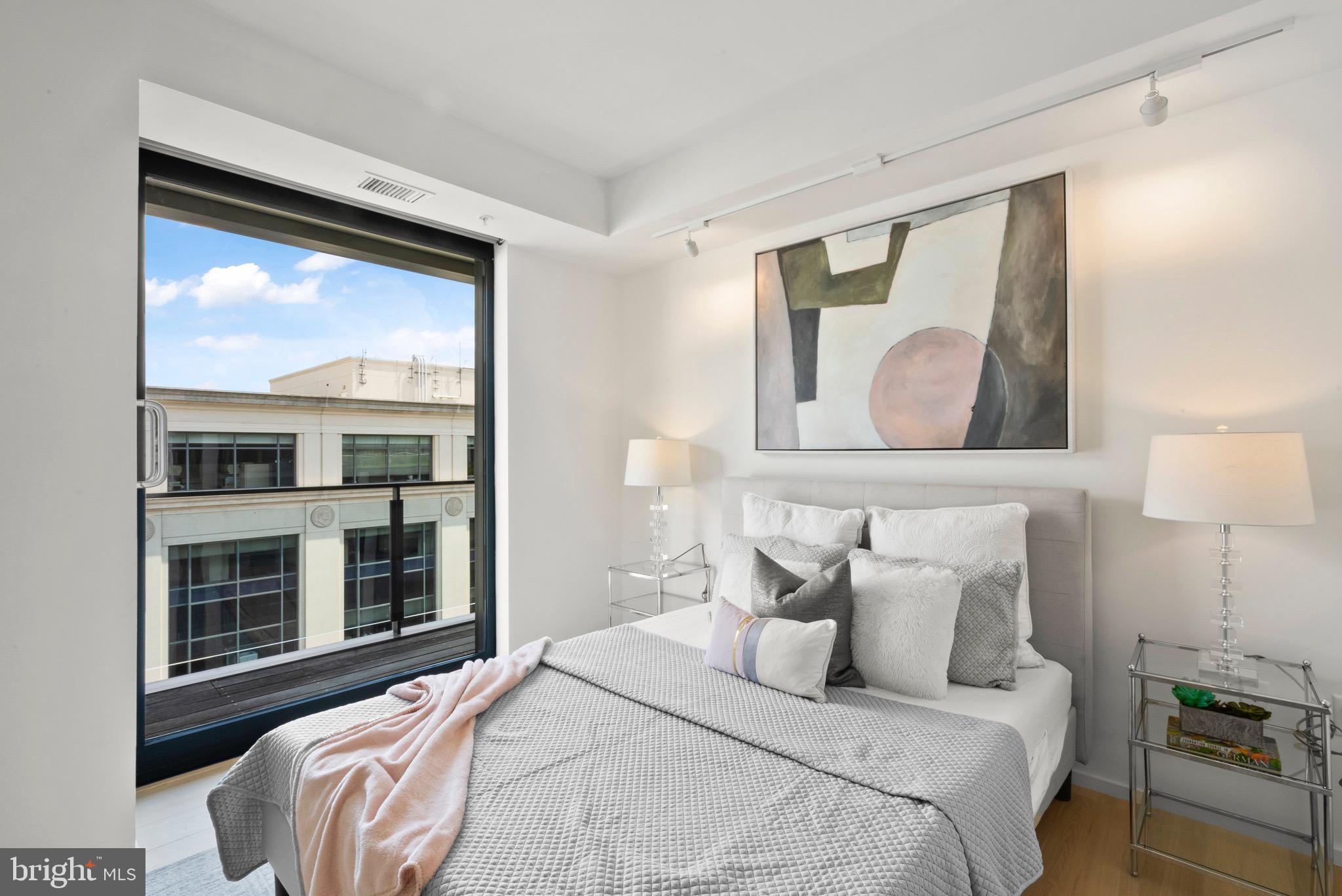 920 I Street Northwest, Unit 1009 Washington, DC 20001 - Photo 7 of 75 a bedroom with a bed and a large window