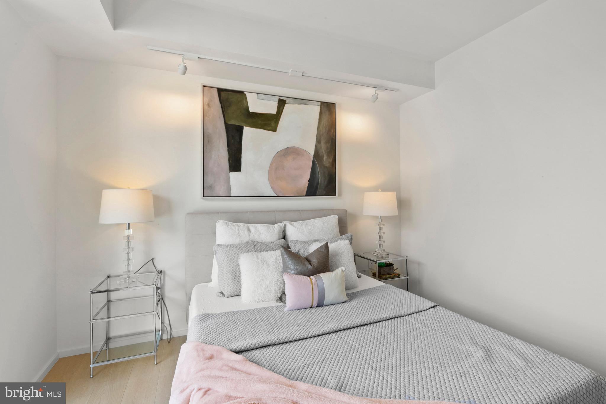 920 I Street Northwest, Unit 1009 Washington, DC 20001 - Photo 8 of 75 a bedroom with a bed and a night stand