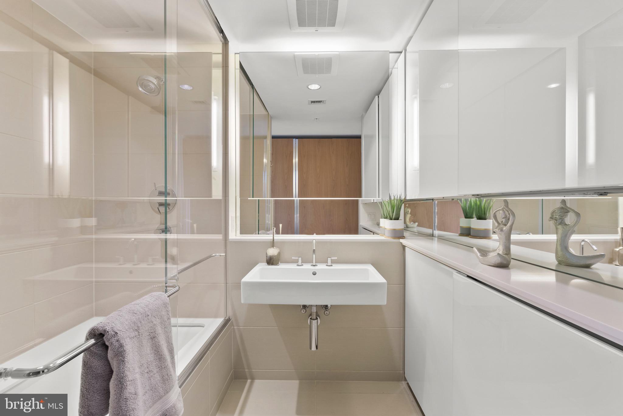 920 I Street Northwest, Unit 1009 Washington, DC 20001 - Photo 10 of 75 a bathroom with a sink and a mirror