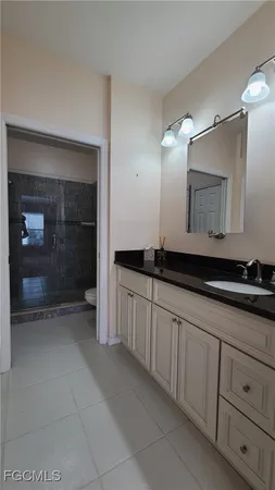 a bathroom with a shower a toilet and sink