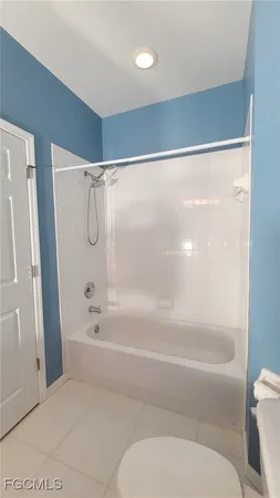 a utility room with cabinets washer and dryer