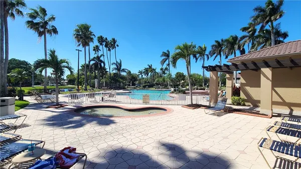 a view of swimming pool with a table and chairs