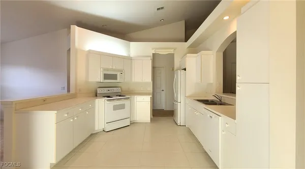 a view of a kitchen with a sink and dishwasher