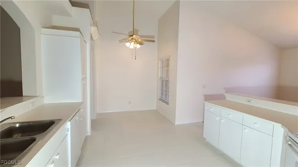 a view of kitchen with a sink and a stove