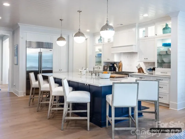 a large kitchen with a table and chairs