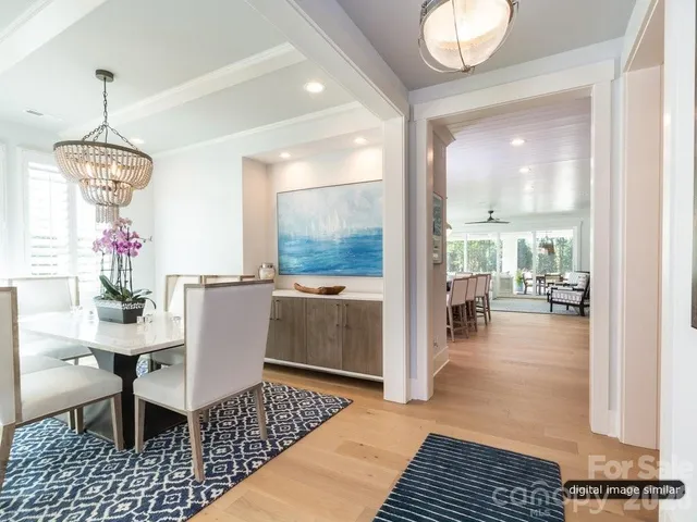 a dining room with furniture a chandelier and wooden floor