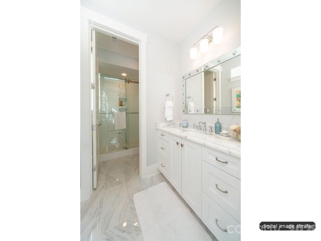 134 Willow Vw Loop, Unit 1 Davidson, NC 28036 - Photo 25 of 42 a bathroom with a sink a mirror and a shower