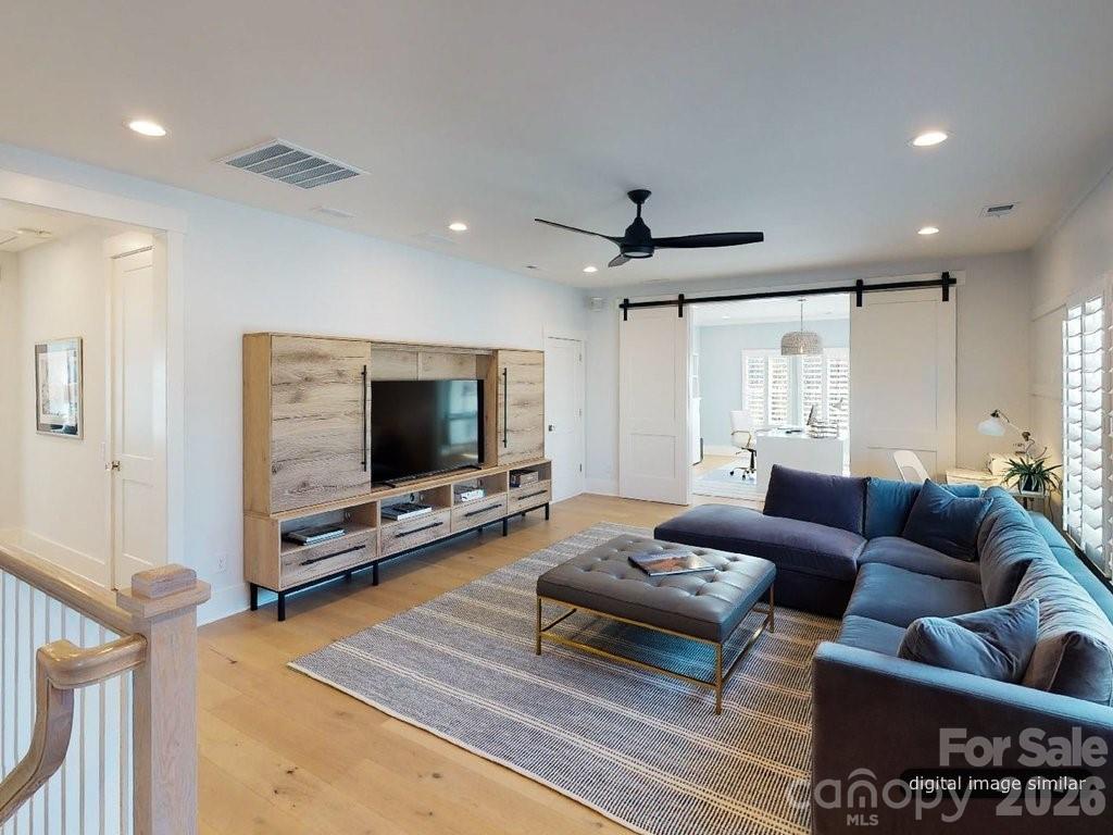 134 Willow Vw Loop, Unit 1 Davidson, NC 28036 - Photo 29 of 42 a living room with furniture and a flat screen tv