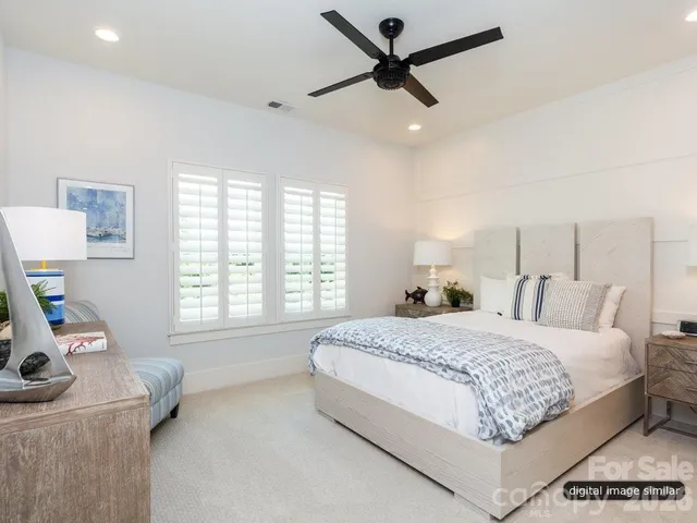 a bedroom with a bed a window and a couch