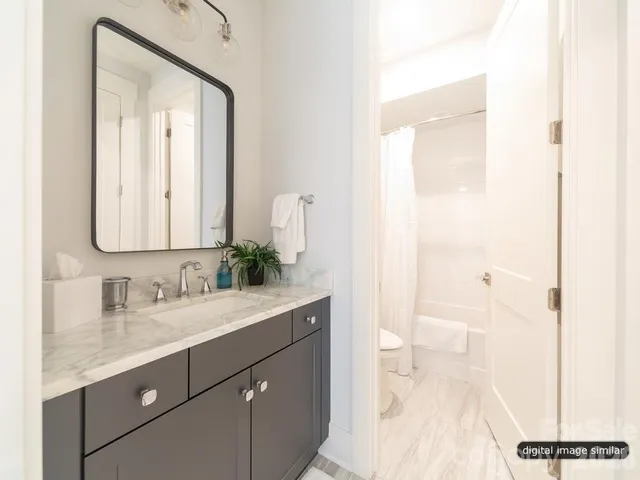 a bathroom with a sink vanity granite and a mirror