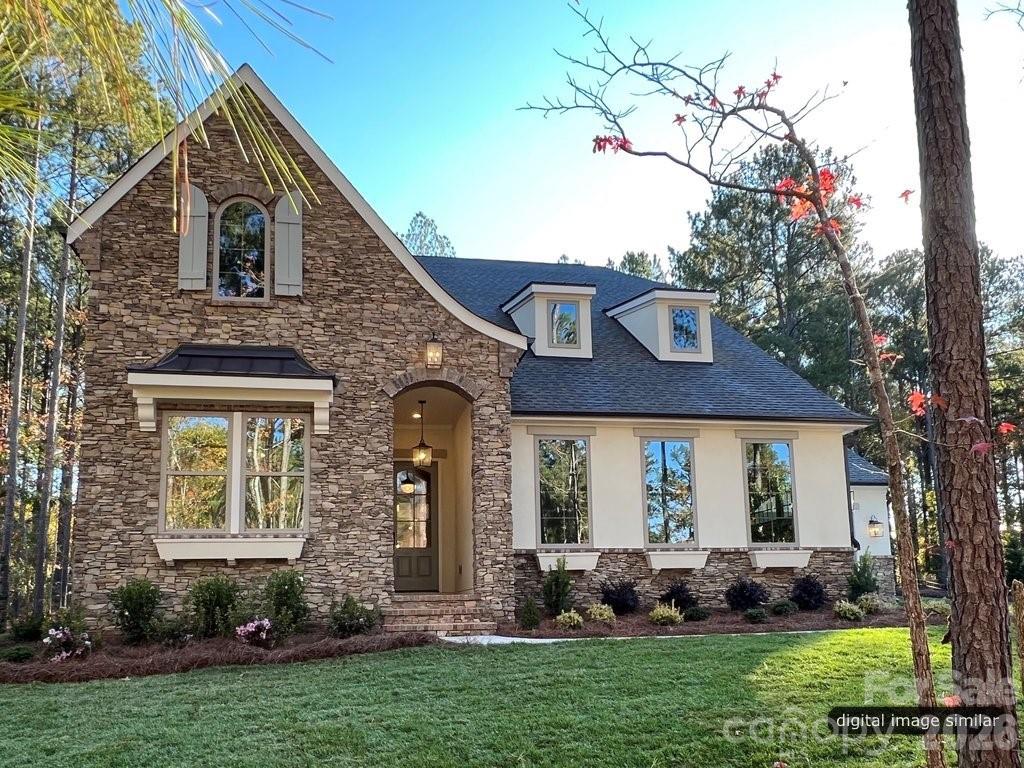 134 Willow Vw Loop, Unit 1 Davidson, NC 28036 - Photo 4 of 42 a front view of a house with a garden