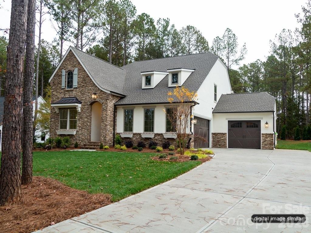 134 Willow Vw Loop, Unit 1 Davidson, NC 28036 - Photo 5 of 42 a front view of a house with a yard and trees