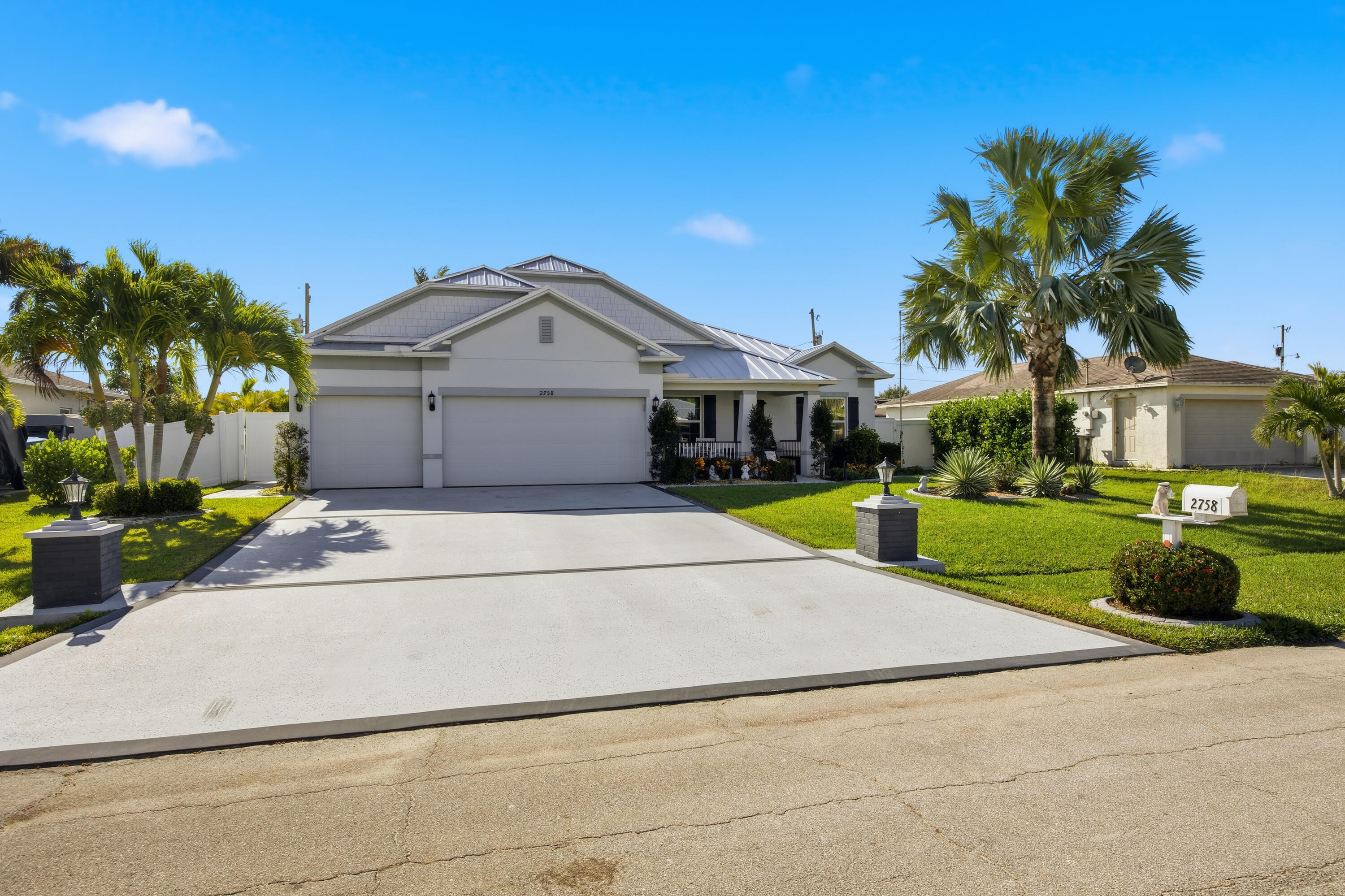 a front view of a house with yard and green space