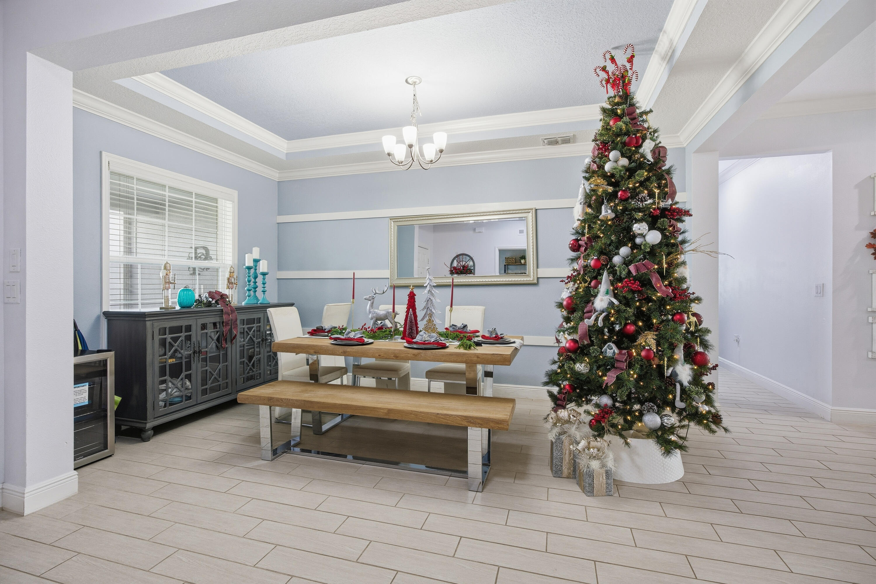 2758 Southwest Onaway Avenue Port St. Lucie, FL 34987 - Photo 11 of 49 a living room with furniture a chandelier and a potted plant