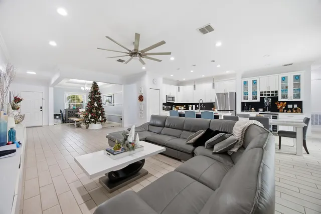 a living room with furniture and kitchen view